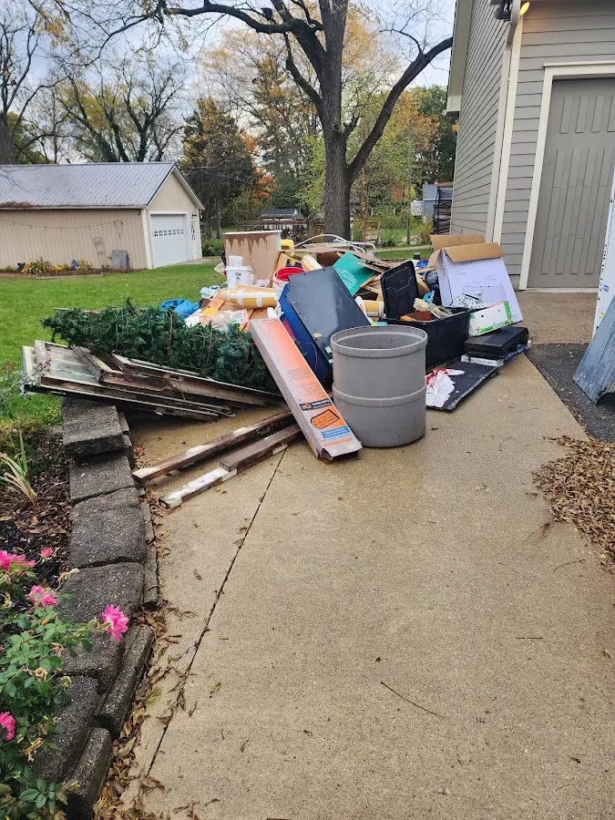 Dumpster being loaded with debris for Roofing Dumpster Rental in Pelham